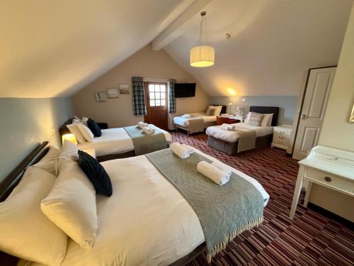 a hotel room with two beds and a living room at The Workshop in Aberystwyth