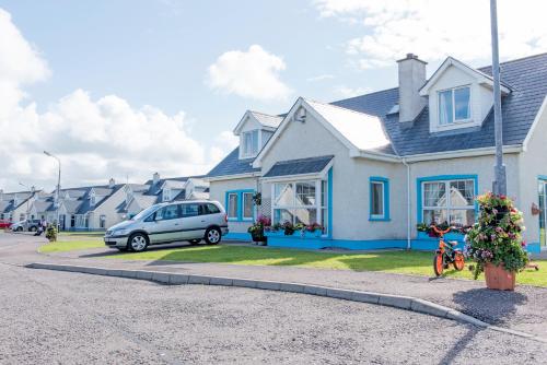 a house with a car parked in front of it at Portbeg Holiday Homes at Donegal Bay in Bundoran