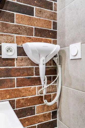 a security camera is attached to a brick wall at Comédie ST-Roch - T2 - Hypercentre Gare - CLIM & NETFLIX in Montpellier