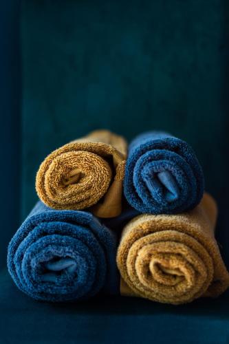 a pile of blue towels stacked on top of each other at Balcarres, Rodborough Avenue in Stroud