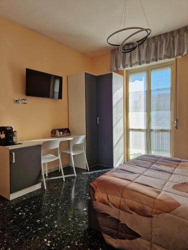 a bedroom with a bed and a desk and a television at B&B Comfort Room 93 in Benevento
