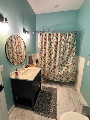 a bathroom with a shower curtain and a sink at Yellowstone Hideaway in Livingston