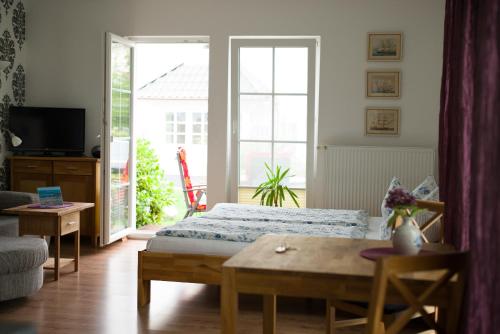 a living room with a bed and a table at Ferienhaus Kaptein Meyer in Zingst