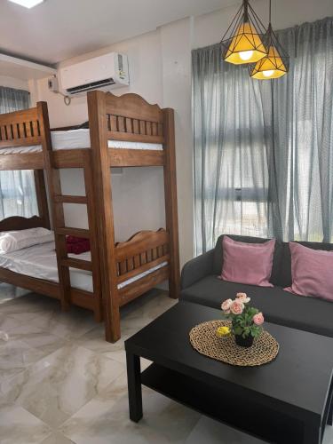 a living room with a couch and bunk beds at Marinelli Beach Resort in San Agustin