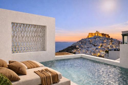 a villa with a swimming pool with a view of a building at Astypalaia Hotel Palace in Astypalaia