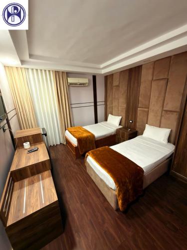 a hotel room with two beds and a table at Panorama Portsaid Hotel in Port Said