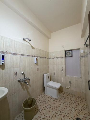 a bathroom with a toilet and a sink at Naidu Villa in Secunderabad