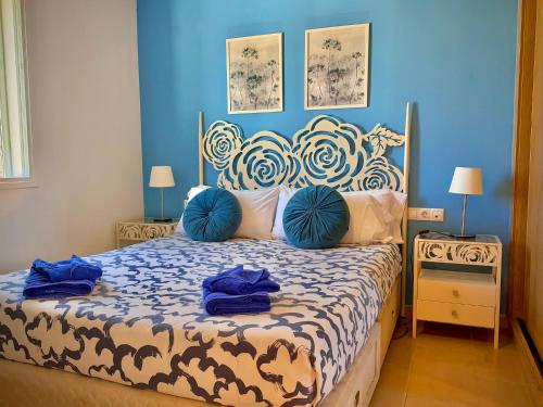 a bedroom with a large bed with blue walls at Delfines 61 in Corralejo