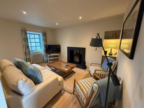 a living room with a couch and a table at Gilchrist Square in Dornoch
