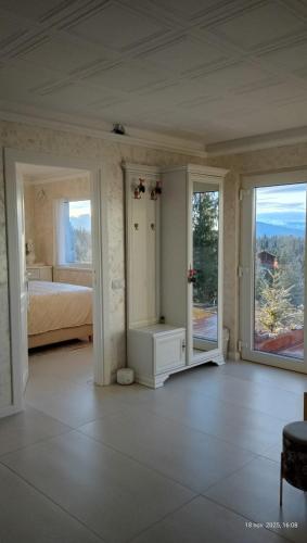 a bedroom with a bed and sliding glass doors at Harmony Retreat in Dealu Negru