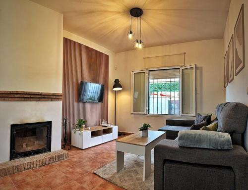 a living room with a couch and a fireplace at Ronko House El Ronquillo in El Ronquillo