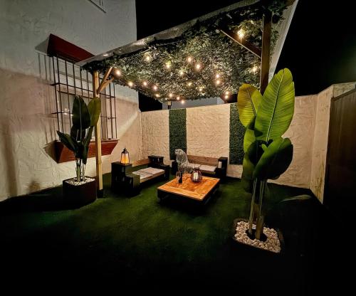 a living room with a couch and a table and plants at Ronko House El Ronquillo in El Ronquillo