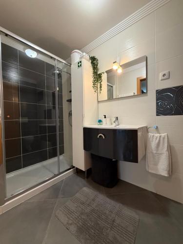 a bathroom with a sink and a shower at Vela Terrace in Monte Gordo