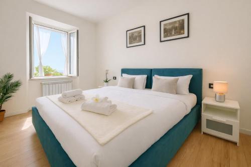 a bedroom with a large bed with two towels on it at Como Lake View in Brienno