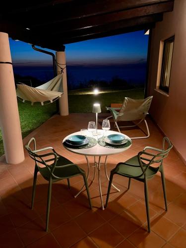 a table and chairs on a patio at night at GREEN APARTMENT in VILLA ANGISI in Drapia