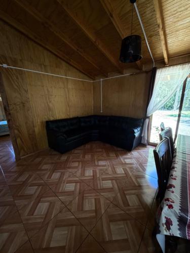 a living room with a couch in a room at Cabañas El Rincón De Huallerupe in Melipeuco