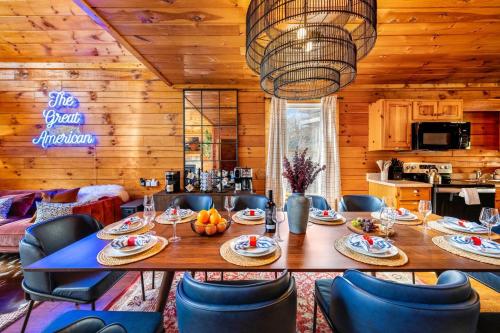 a dining room with a large wooden table and chairs at 15 min Dollywood, Game room, Hot tub, Shared pool, Pets Welcome in Pigeon Forge