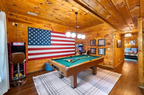 a pool table in a room with an american flag on the wall at 15 min Dollywood, Game room, Hot tub, Shared pool, Pets Welcome in Pigeon Forge
