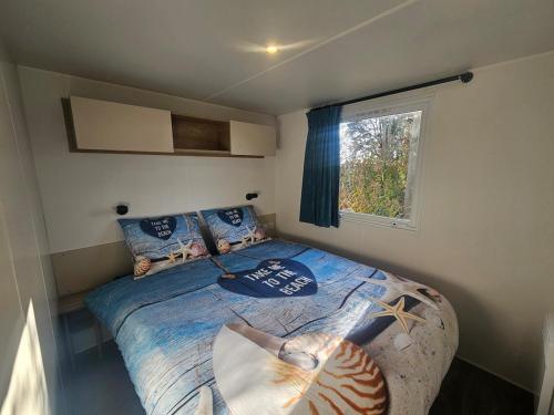 a bedroom with a bed in a small room at Chalet First Stage - Renesse in Renesse