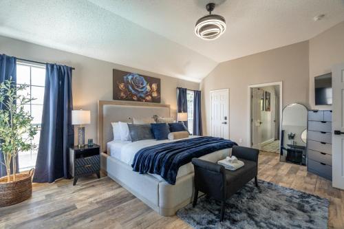 a bedroom with a bed and a chair in a room at Stylish Oasis Modern Living in Allen