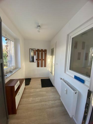 a room with a hallway with a sink and a window at Möwennest in Barsbek