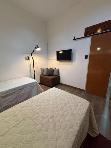 a hotel room with two beds and a couch at Sarr in Santa Fe