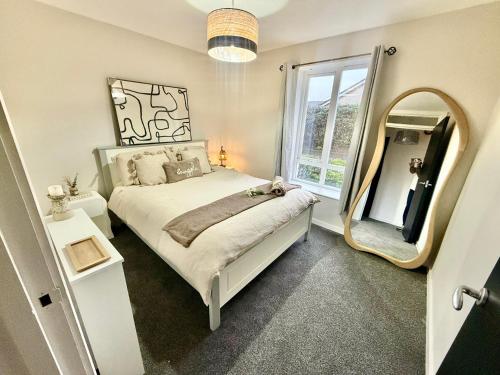 a bedroom with a bed and a large mirror at Ebrington apartment central in Clooney Park