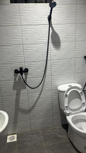 a bathroom with a toilet and a sink at La vue suites in Kampala