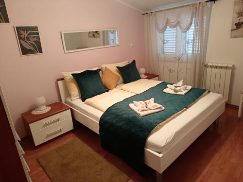 a bedroom with a bed with towels on it at Appartmani Punta in Umag