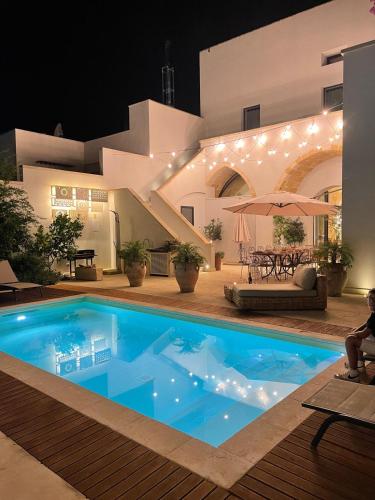 a swimming pool in a house at night at Palazzo Flora in Collepasso