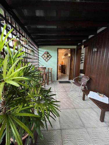 a patio with tables and chairs and plants at Familien Haus Pousada in Pomerode