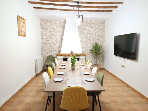 a large dining room with a long table and chairs at Señorío de Ves in Casas de Ves