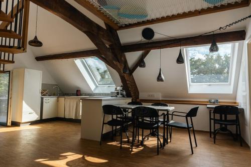 a kitchen with a table and chairs in a room at Cosy Eco-Loft in Pettingen