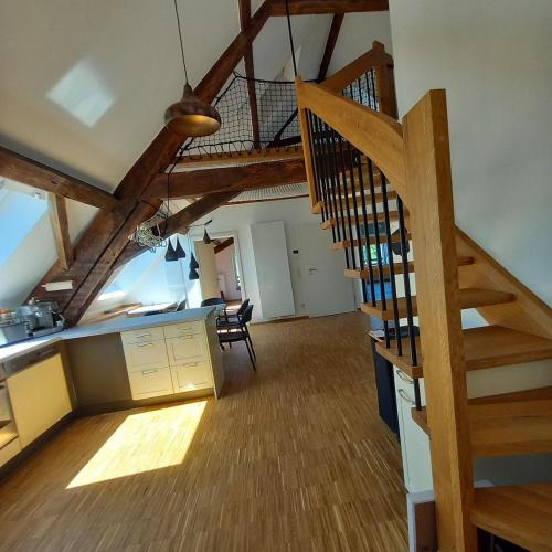 a kitchen with a staircase and a living room at Cosy Eco-Loft in Pettingen