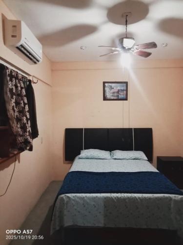 a bedroom with a bed and a ceiling fan at Casa de ámbar cuatunalco in Cuatunalco