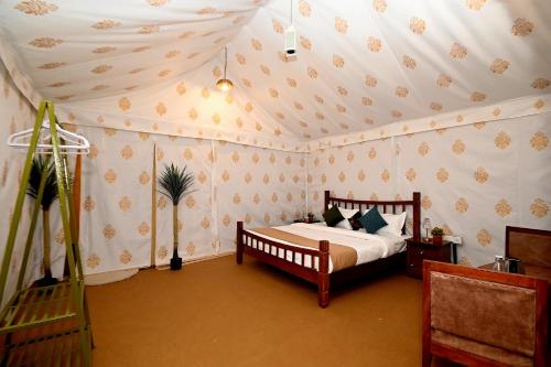 a bedroom with a bed in a room at Baghin Resort in Khilchipur