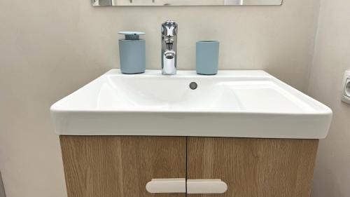a bathroom sink with two cups on top of it at Rhys Houses in Altea