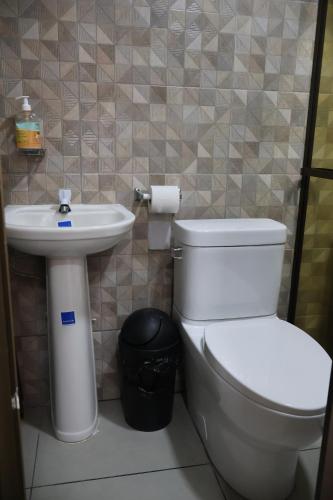 a bathroom with a toilet and a sink at Hospedaje Ofe,S #3 in Santiago