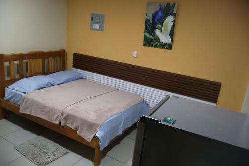 a bedroom with a bed and a flat screen tv at Hospedaje Ofe,S #3 in Santiago