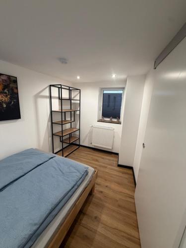 a bedroom with a bed and a book shelf at Zauberhafte Erdgeschoss-Maisonettewohnung in Bovenden