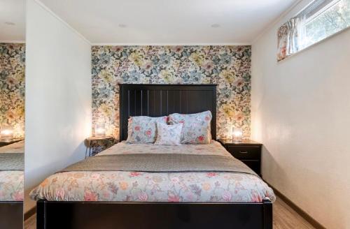 a bedroom with a large bed with floral wallpaper at Suite 17 in Eindhoven
