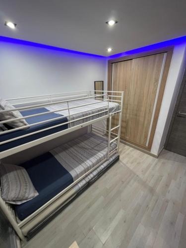 a room with two bunk beds and a door at Habitaciones privadas in Madrid