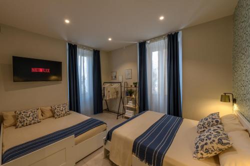 a bedroom with two beds and a window at Bastioni Central Apartment in Civitavecchia