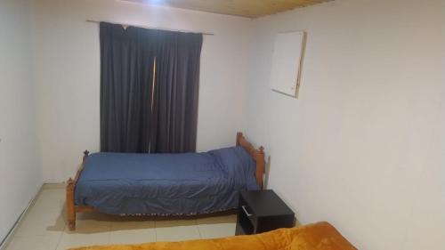 a small room with a bed and a window at Cabaña Mailin II in Uspallata