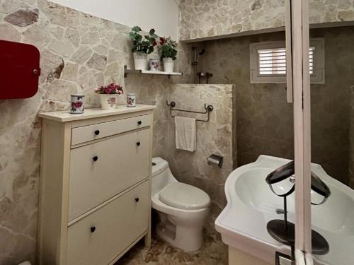 a bathroom with a white toilet and a sink at Habitat Samaná Apartments - Coral Samanà in Los Corozos
