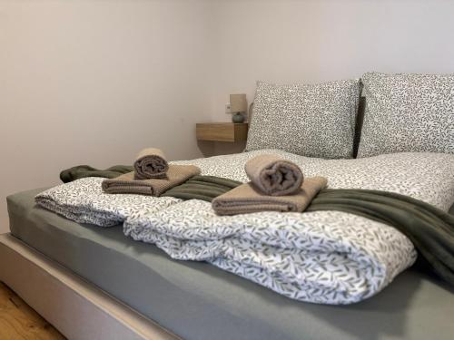 a bed with towels and pillows on it at Apartment Leitner in Haiming