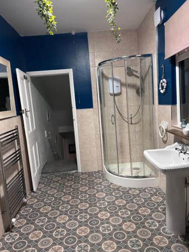 a bathroom with a shower and a sink at Kraken Cottage in Bridlington