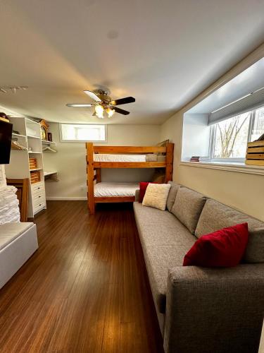 a living room with a couch and a bunk bed at Hiltz House Cellar Suite Near Halifax Ferry in Halifax