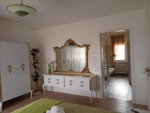 a room with a dresser with a mirror on it at Violetta in Minerbio