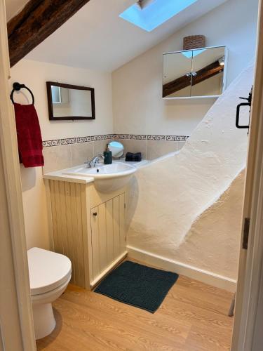 a bathroom with a sink and a toilet at The Old Stores in Bury Saint Edmunds